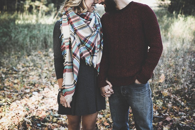 A happy couple walks hand in hand through a park - symbolizing emotional closeness, connection, and the positive outcomes of successful marriage and couples therapy