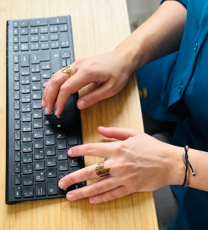 Online psychologist chatting with a client - hands on keyboard at desk, digital psychological therapy and counselling via videocall, audicall and chat