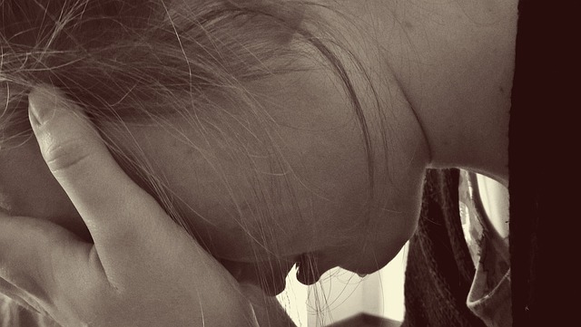 Heartbreak: at World's End! - Woman sits crying with her head in her hands - symbolises the pain of separation, coping with heartache and the emotional pain after a break-up