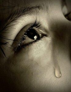 Understanding and overcoming Weltschmerz - child with a tear on its face as a symbol of world-weariness - emotional representation of compassion and inner pain